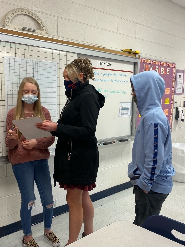 Mrs. Maynard assisting students with a scavenger hunt.  