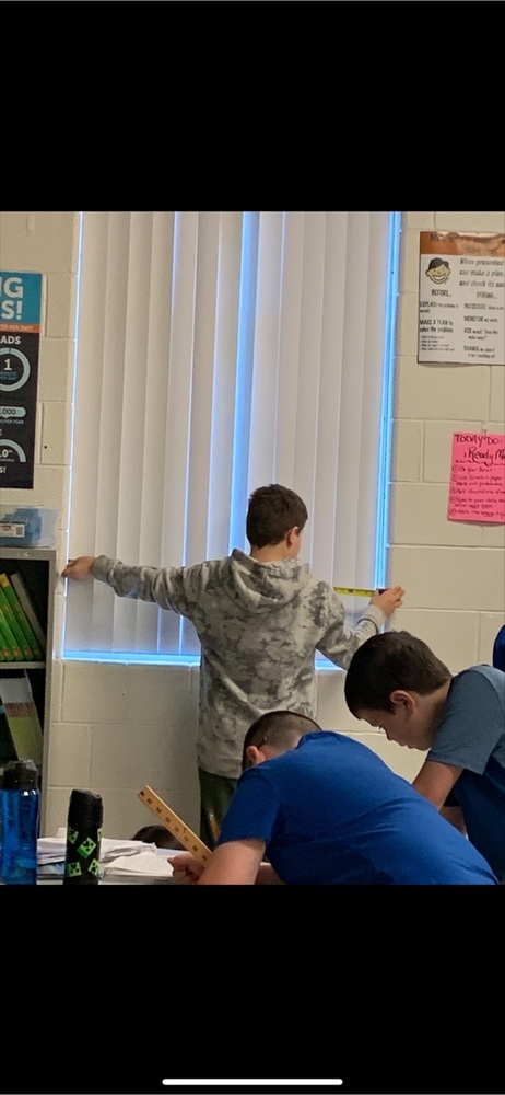A 4th grade student working on his assignment