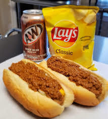 two hot dogs, chips, can of root beer