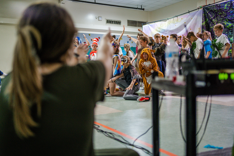 Ms. Watson looking on as her students perform a dance number.